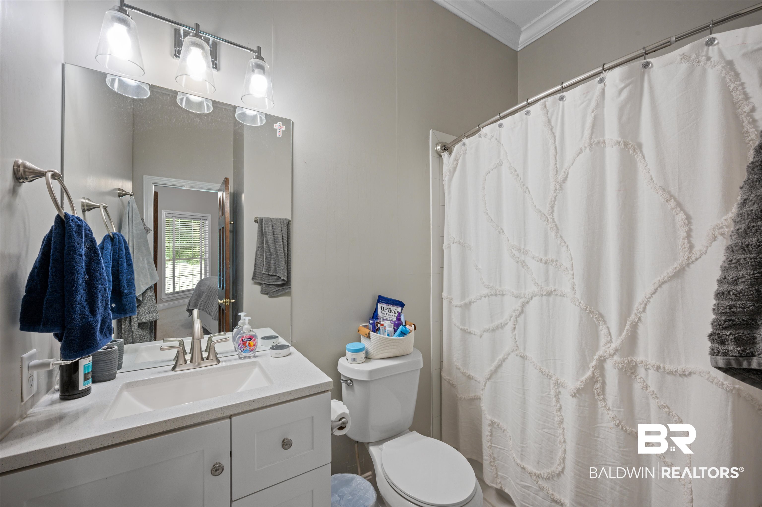 141 Blue Ridge Drive Monroeville, AL 36460 - Photo 19 of 40 Full bathroom with ornamental molding, vanity, and a shower with shower curtain