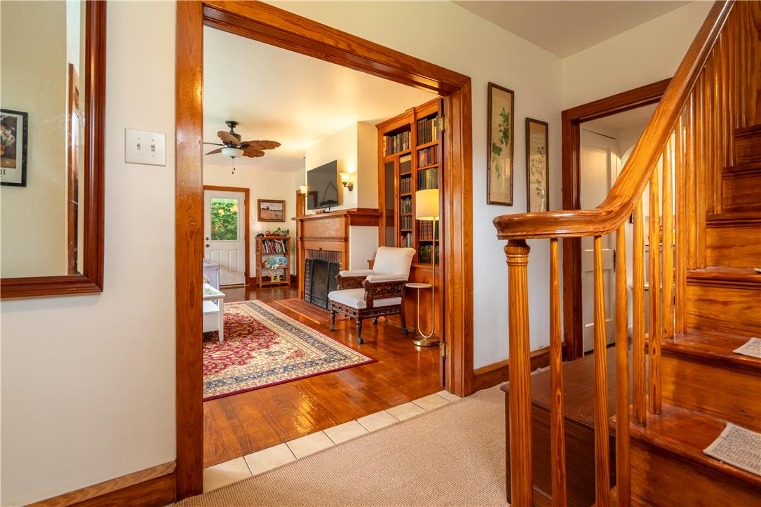 665 Point Phillips Road Bath, PA 18014 - Photo 5 of 73 Rich hardwood floors flow through this inviting living area, featuring a cozy fireplace and built-in bookshelves.
