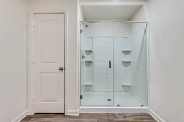a bathroom with a glass shower door