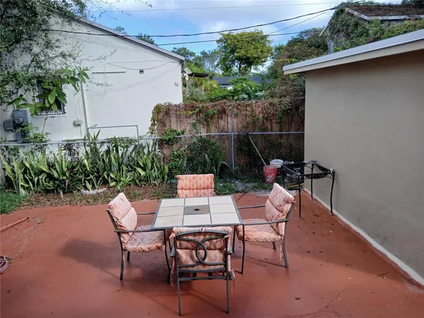 a patio with table and chairs
