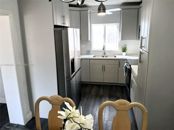 a kitchen with stainless steel appliances granite countertop a refrigerator and a sink