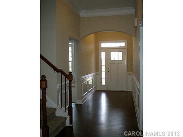 78014 Rillstone Drive, Unit 184 Lancaster, SC 29720 - Photo 3 of 16 a view of a hallway with wooden floor