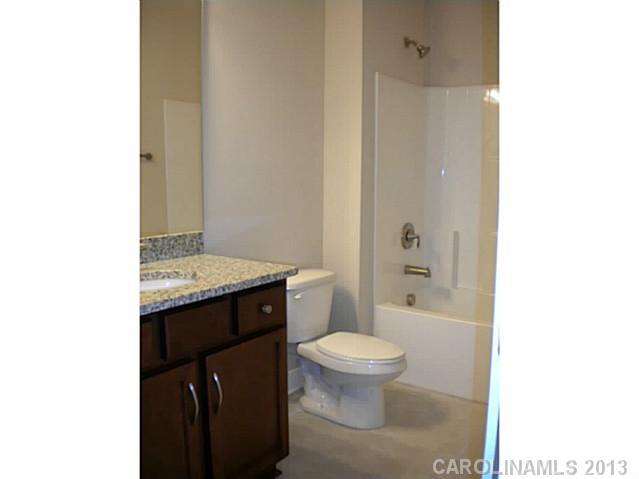 78014 Rillstone Drive, Unit 184 Lancaster, SC 29720 - Photo 5 of 16 a bathroom with a granite countertop sink toilet and shower