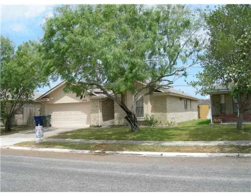 a house that has a tree in front of it