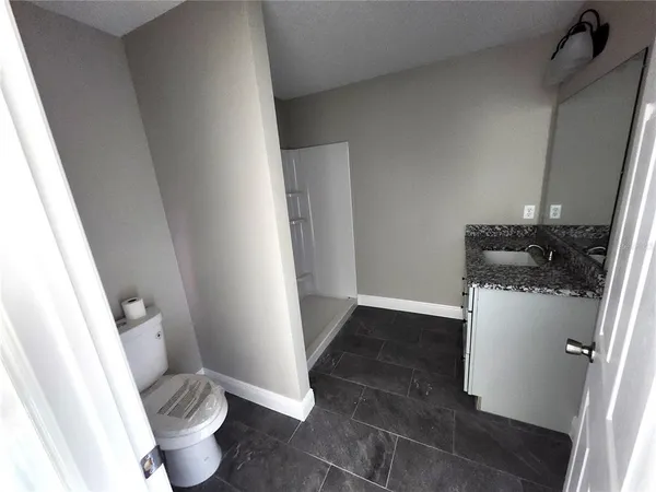 a white toilet sitting next to a sink