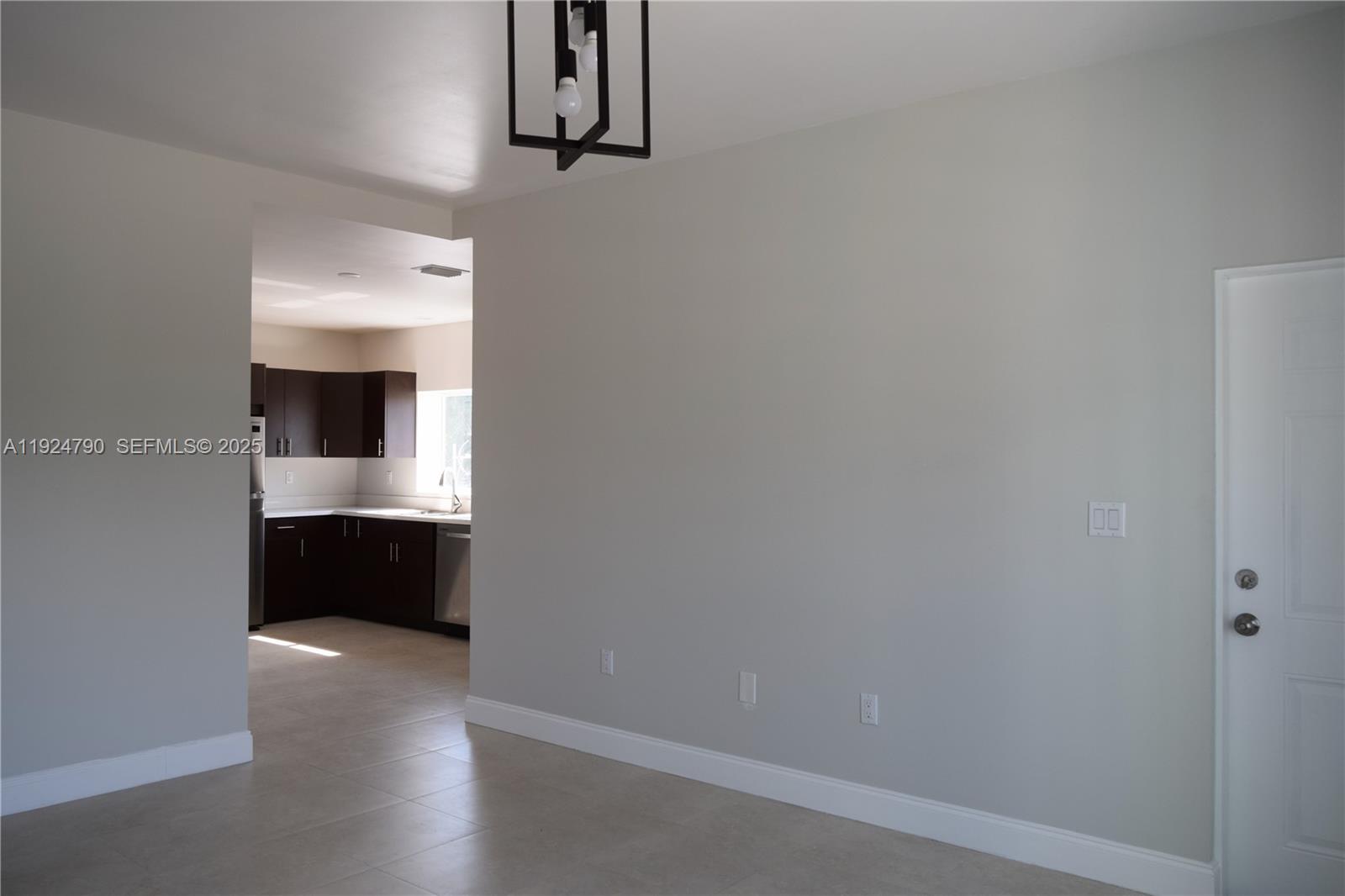 435 Southwest 78th Court Miami, FL 33144 - Photo 5 of 19 a view of an empty room and a kitchen