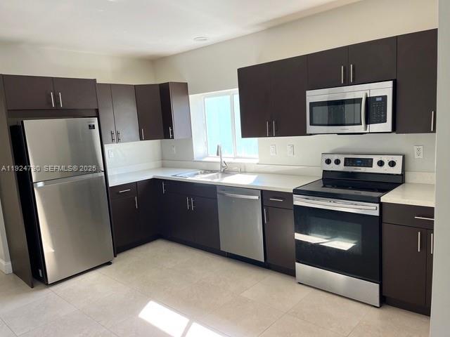 435 Southwest 78th Court Miami, FL 33144 - Photo 7 of 19 a kitchen with stainless steel appliances granite countertop a refrigerator stove and microwave