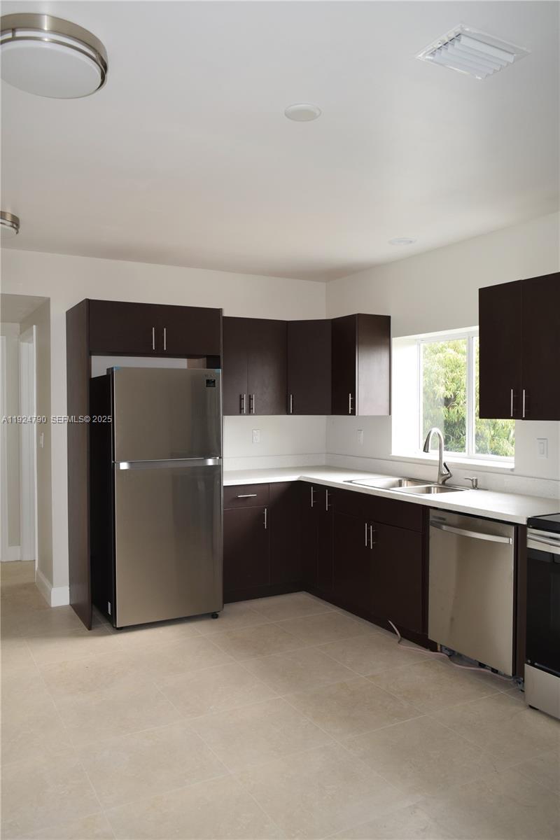 435 Southwest 78th Court Miami, FL 33144 - Photo 8 of 19 a large kitchen with granite countertop a sink and cabinets