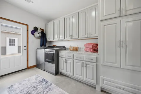 a kitchen with white cabinets and white appliances