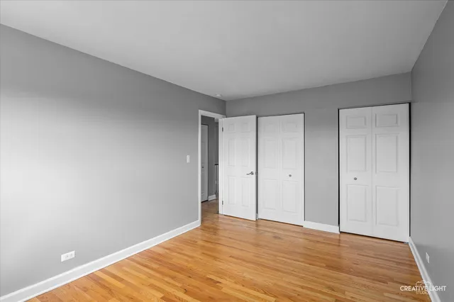 a view of an empty room and wooden floor