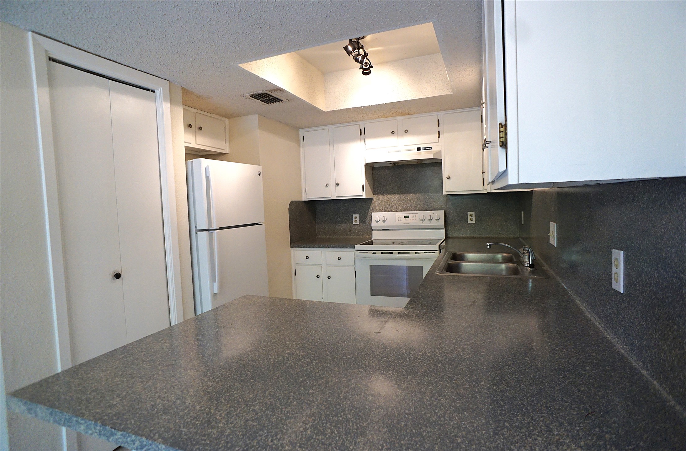 8418 Fathom Circle, Unit C302 Austin, TX 78750 - Photo 3 of 9 a kitchen with stainless steel appliances a refrigerator sink and stove