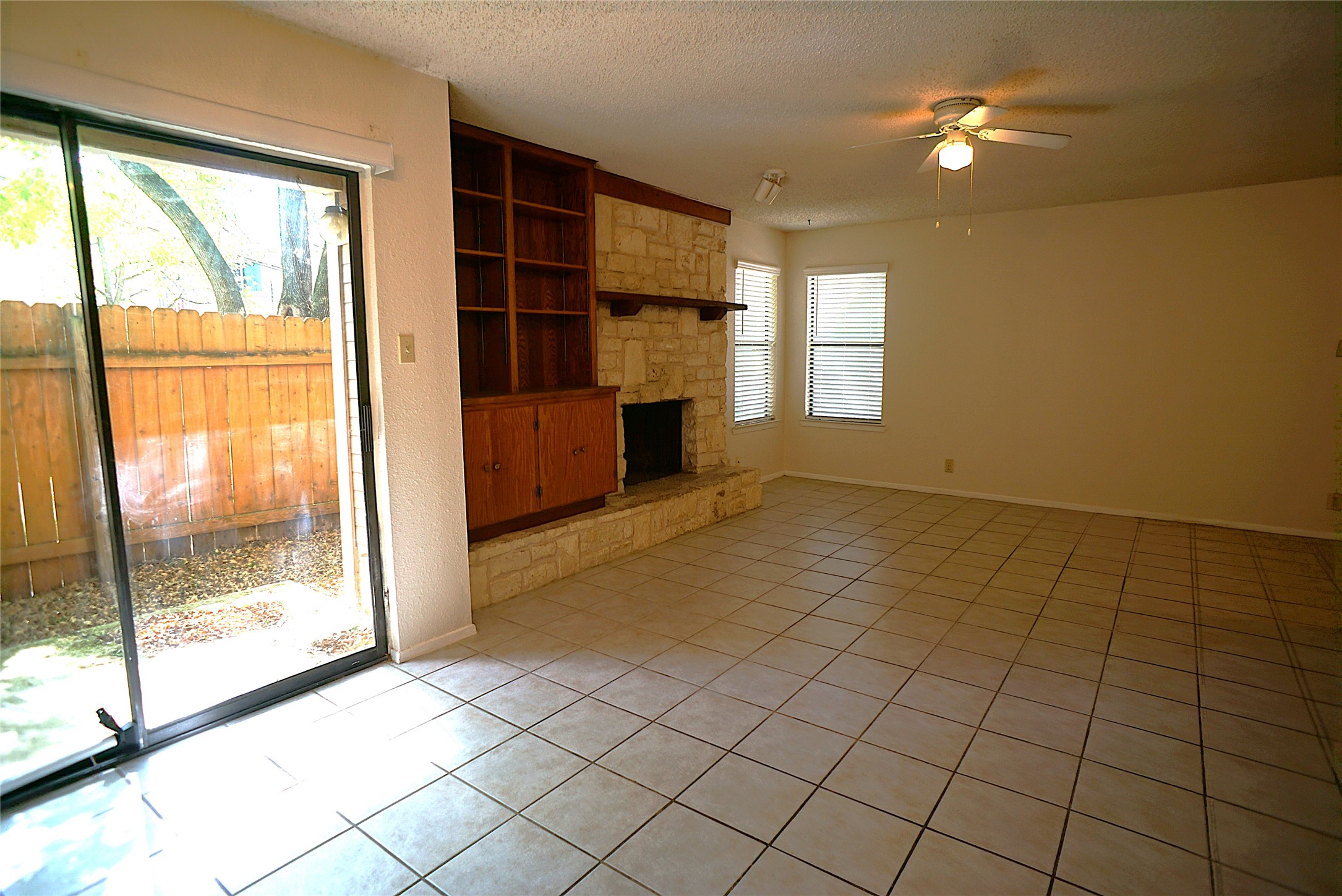 8418 Fathom Circle, Unit C302 Austin, TX 78750 - Photo 4 of 9 a view of empty room with window and fireplace