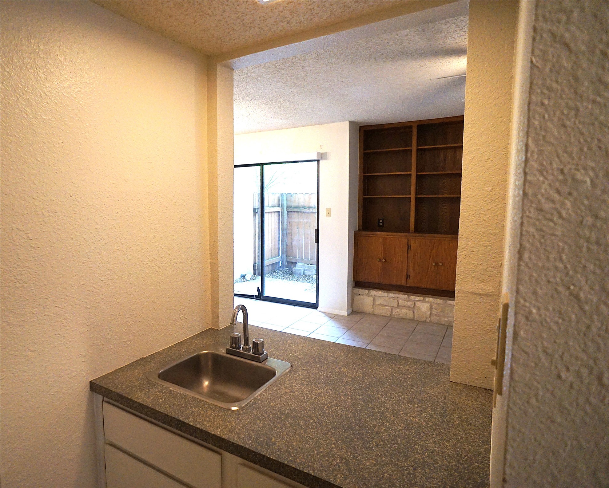 8418 Fathom Circle, Unit C302 Austin, TX 78750 - Photo 5 of 9 a bathroom with a granite countertop sink and a mirror