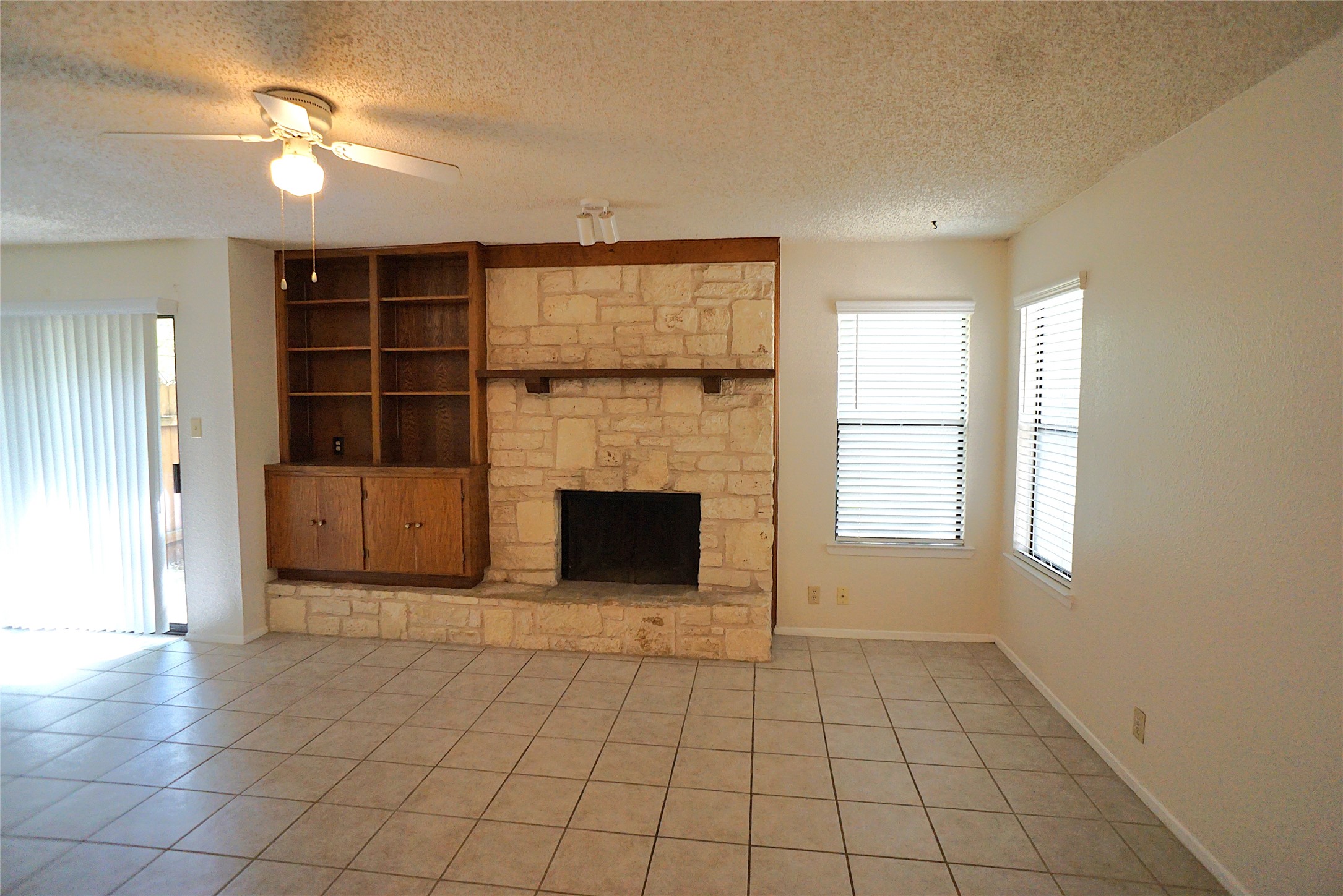 8418 Fathom Circle, Unit C302 Austin, TX 78750 - Photo 8 of 9 an empty room with windows and fireplace