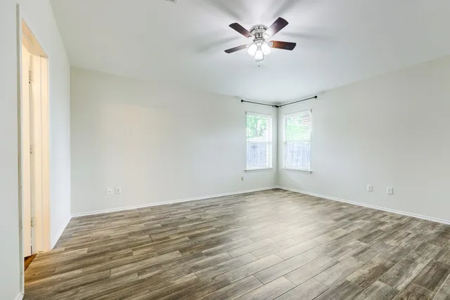 wooden floor in an empty room with a window