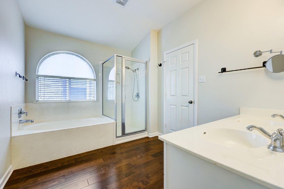 12017 Buzz Schneider Lane Austin, TX 78748 - Photo 5 of 11 a bathroom with a bathtub and a sink