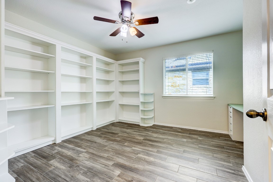 12017 Buzz Schneider Lane Austin, TX 78748 - Photo 6 of 11 a view of empty room with wooden floor and fan