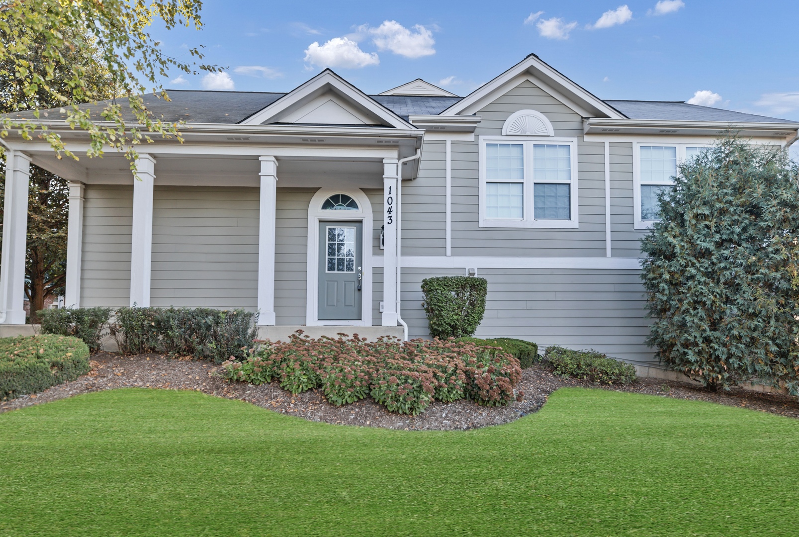 a front view of a house with a yard