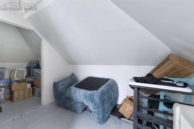 a bedroom with a bed and a lamp