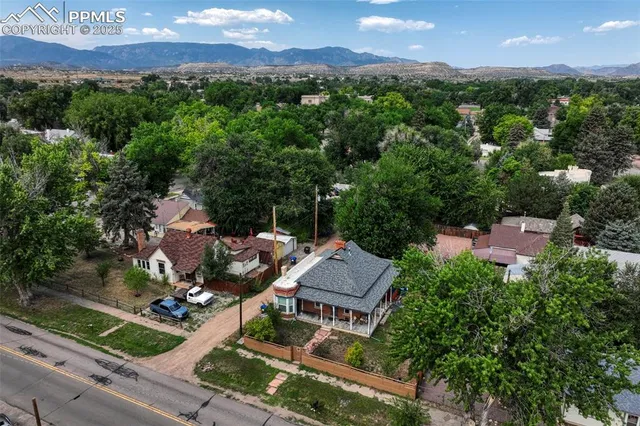 an aerial view of residential houses with outdoor space and ocean view