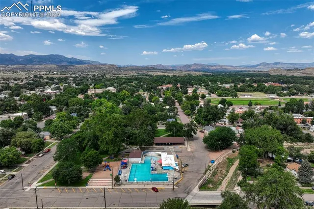 a view of a city with lots of residential buildings and mountain view in back