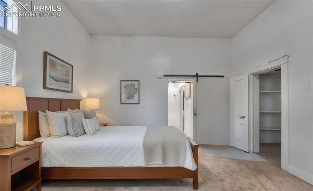 a bedroom with a bed and a view of bathroom