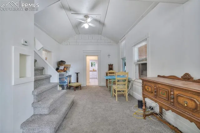a living room with furniture a window and gym equipment