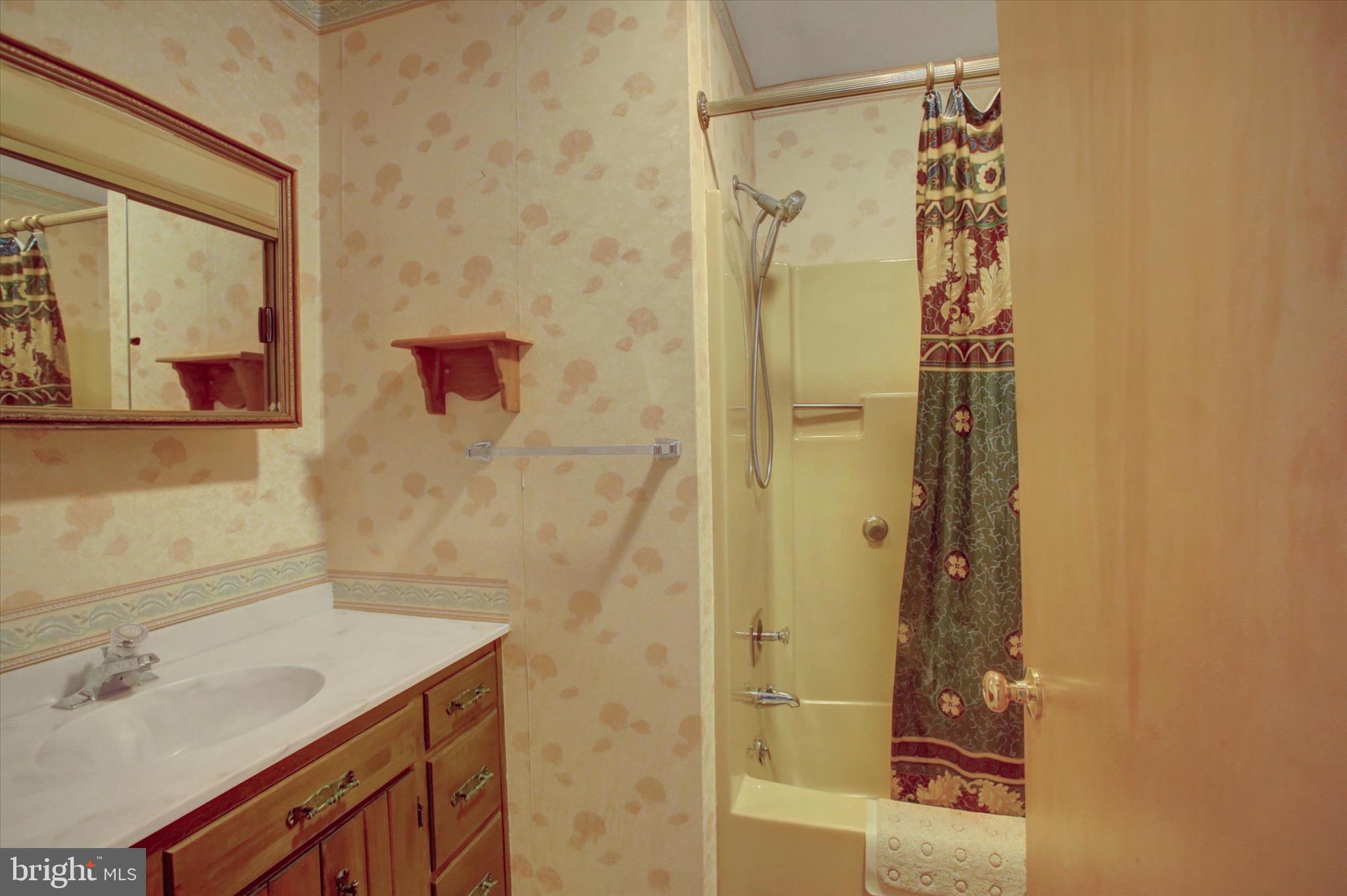 10839 Old Forge Road Waynesboro, PA 17268 - Photo 15 of 48 a bathroom with a granite countertop shower sink vanity and mirror