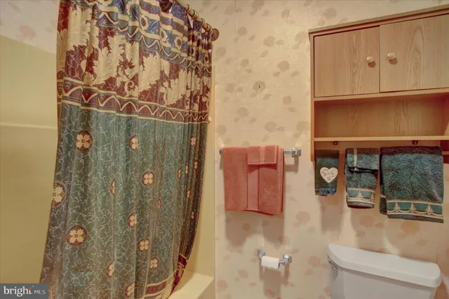 a bedroom with a bed window with table and chair