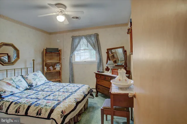 a bedroom with a bed and a dresser in it