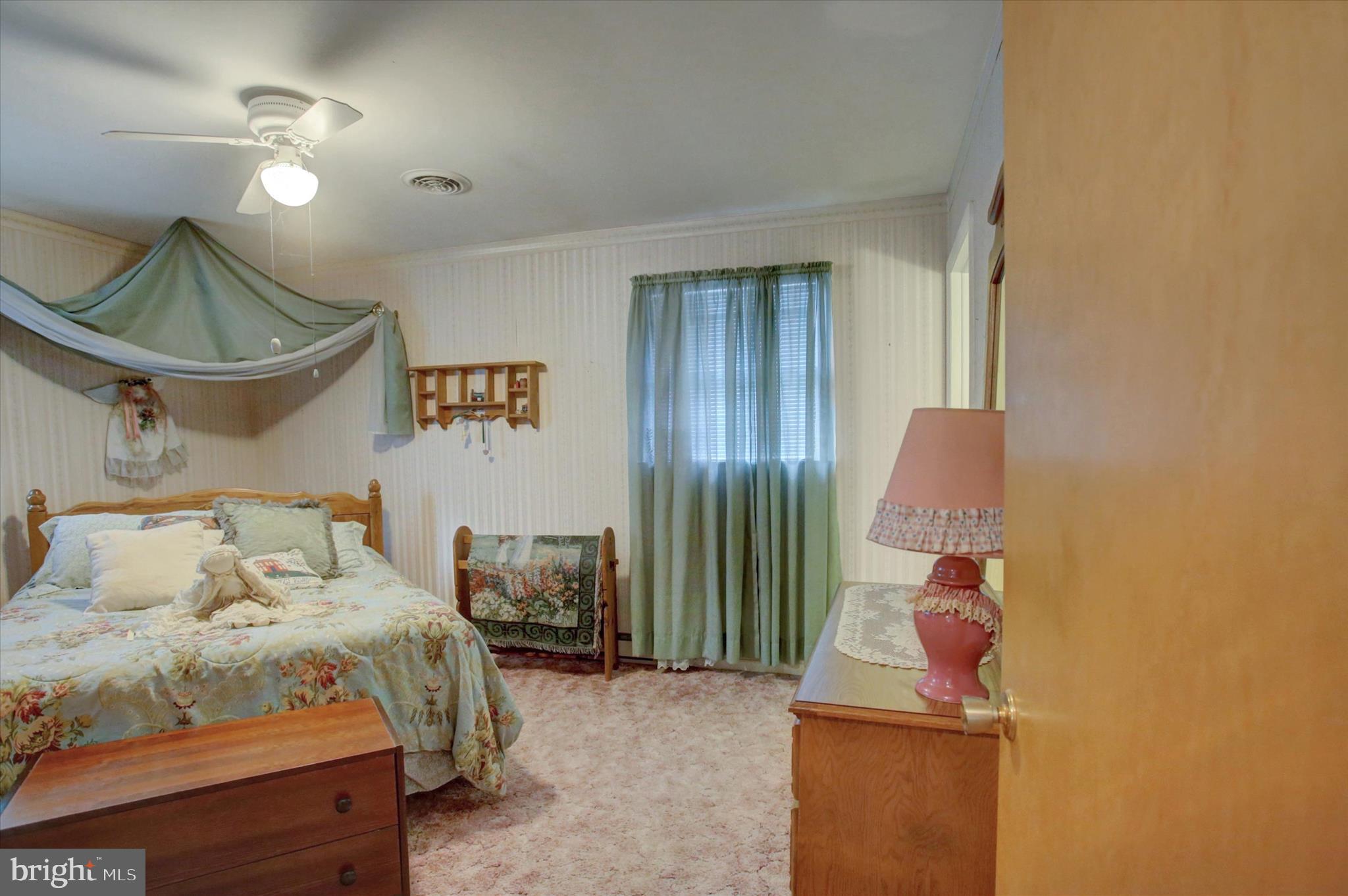 10839 Old Forge Road Waynesboro, PA 17268 - Photo 21 of 48 a bedroom with a bed and a chandelier