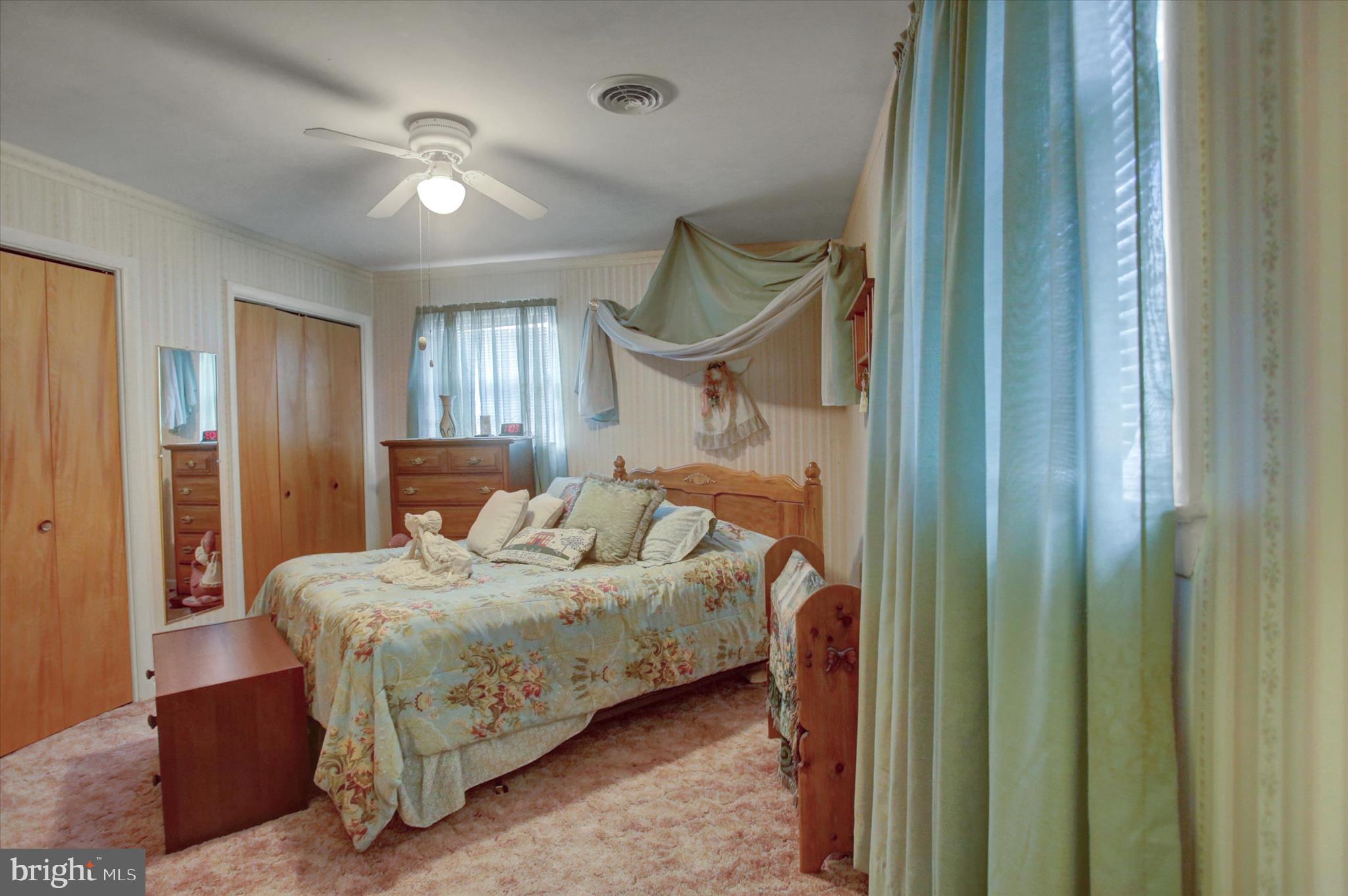 10839 Old Forge Road Waynesboro, PA 17268 - Photo 22 of 48 a bedroom with a bed a mirror and a chandelier