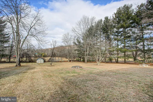 a view of a house with a yard and sitting area