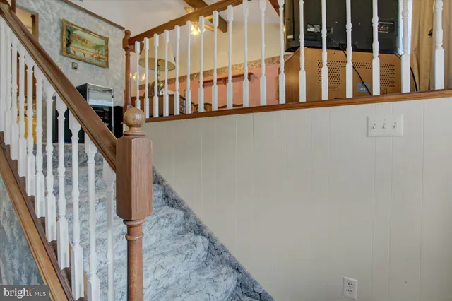 a view of staircase with lots of frames on wall
