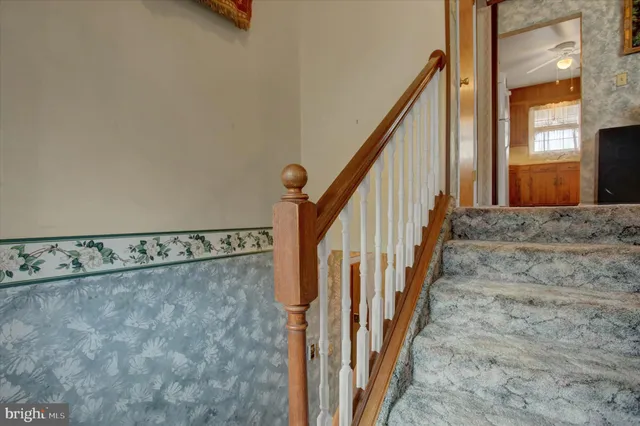 a living room with furniture and a lamp