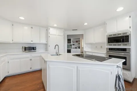 a kitchen with a sink a stove and oven