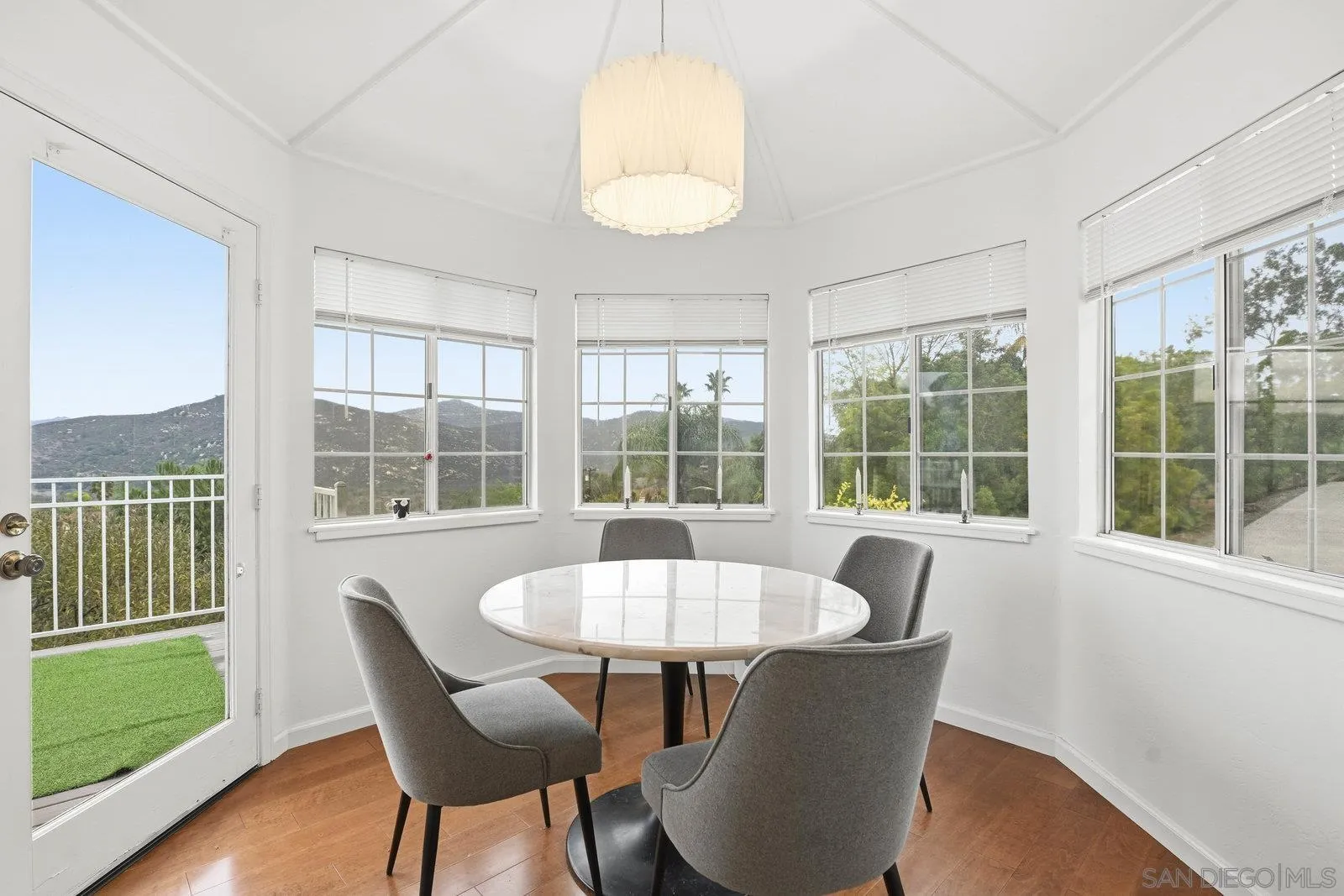 3132 Don Rolando Escondido, CA 92025 - Photo 20 of 34 a dining room with furniture a chandelier and wooden floor