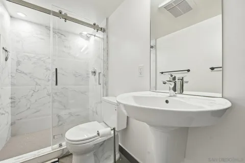 a bathroom with a sink toilet and shower