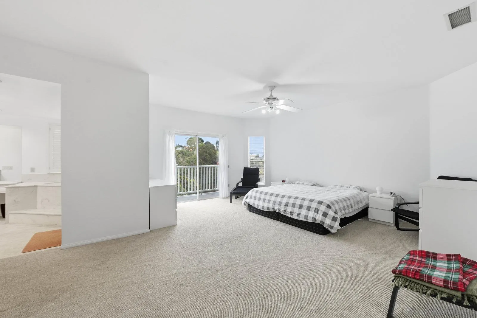 3132 Don Rolando Escondido, CA 92025 - Photo 21 of 34 a spacious bedroom with a bed and a chandelier