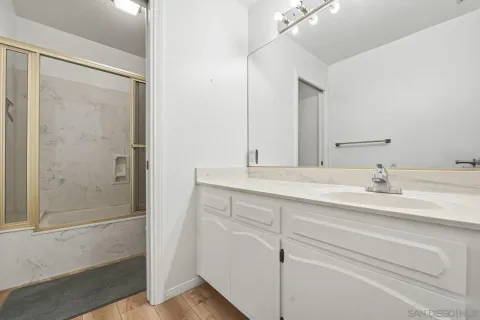 a bathroom with a double vanity sink and a mirror