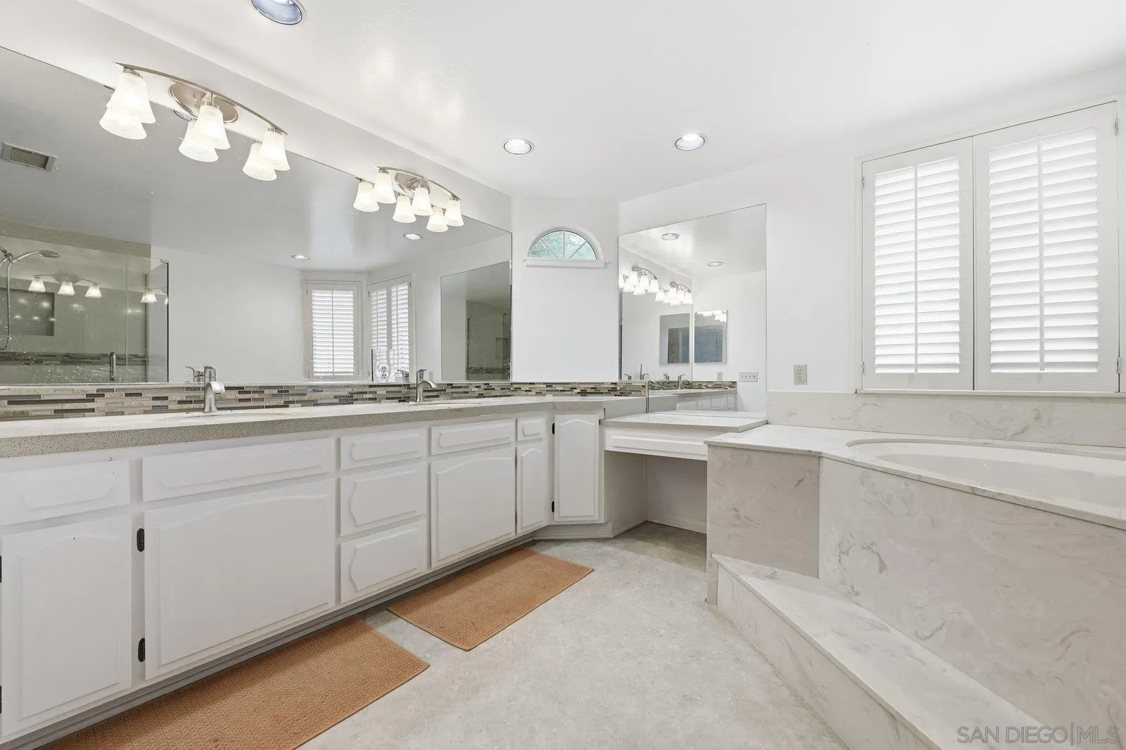3132 Don Rolando Escondido, CA 92025 - Photo 22 of 34 a large bathroom with a large mirror vanity and a sink