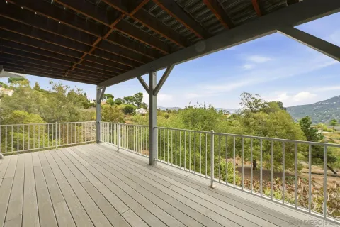 a view of a balcony with wooden floor