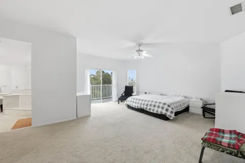 a spacious bedroom with a bed and a chandelier
