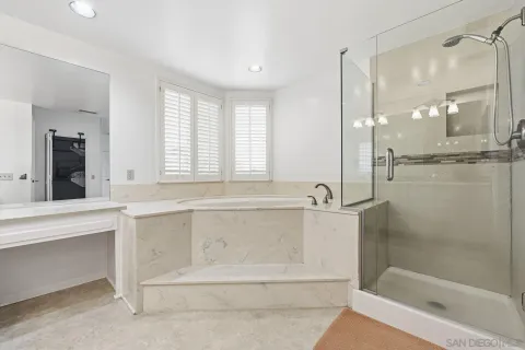 a bathroom with a bathtub and a shower