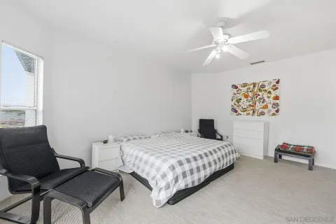 a bedroom with a bed and chair