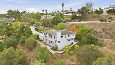 an aerial view of residential house and sandy dunes
