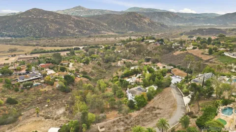 a view of a lush green hillside and houses