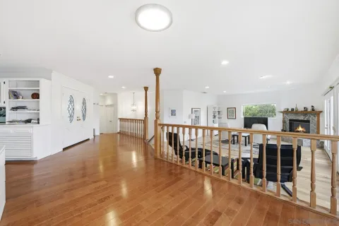 an open area with lots of furniture and wooden floor