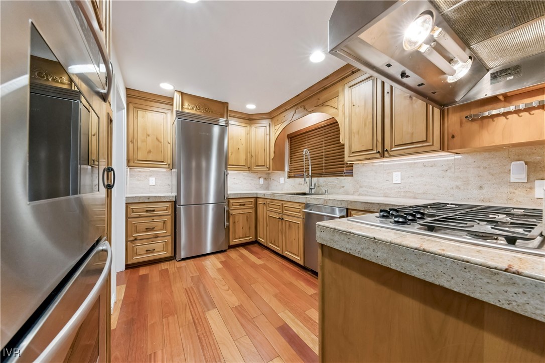 771 Randall Avenue Incline Village, NV 89451 - Photo 11 of 44 a kitchen with stainless steel appliances granite countertop a stove refrigerator and cabinets