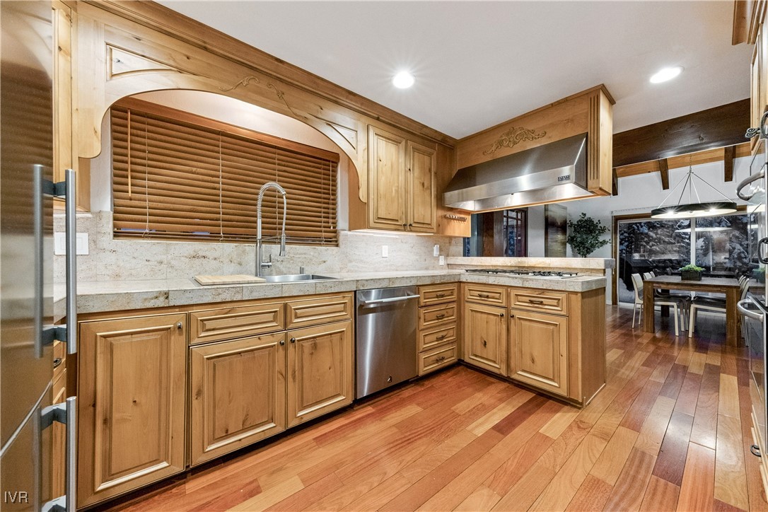 771 Randall Avenue Incline Village, NV 89451 - Photo 12 of 44 a kitchen with stainless steel appliances granite countertop wooden floors and white cabinets